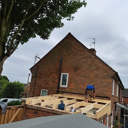 OSB deck being laid on flat roof joists