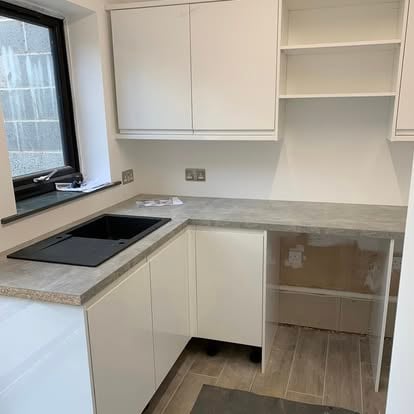White kitchen with stone worktops fitted in new space