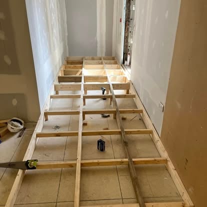 Timber battens laid on corridor floor before new flooring