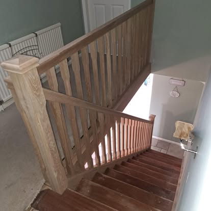 Oak stair balustrade landing view with radiator
