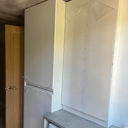 Fitted white wardrobe interior installation