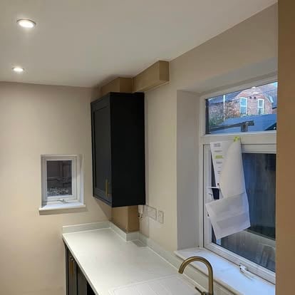 Modern kitchen with dark cabinets recessed lights