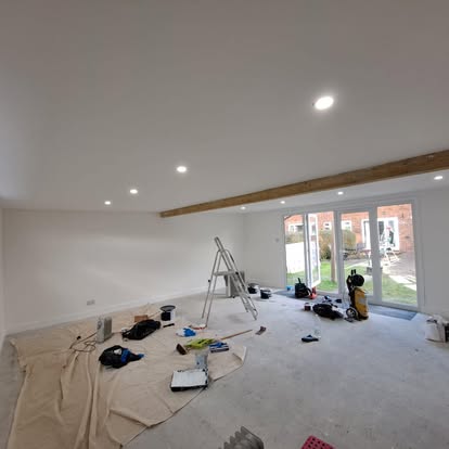 Large room interior with exposed beam and bifolds