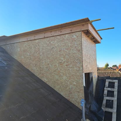 Dormer OSB structure on roof blue sky
