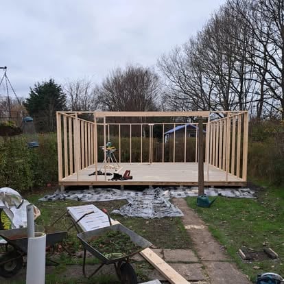 Garden room timber frame being built in garden