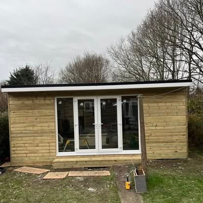Completed garden room with white uPVC French doors