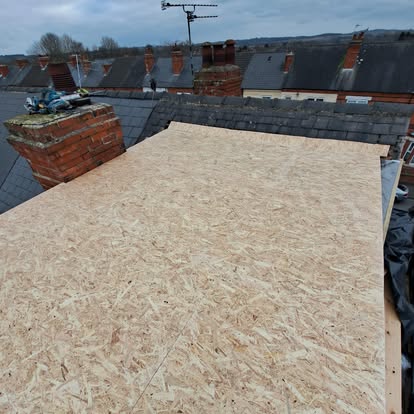 OSB boards on flat roof urban terrace chimneys