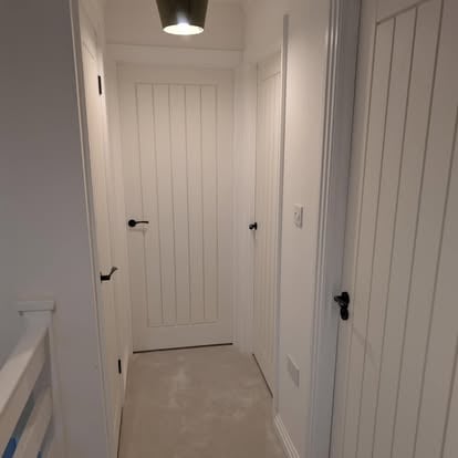 Hallway with three painted white timber doors