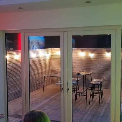 Garden room interior festoon lights bar stools