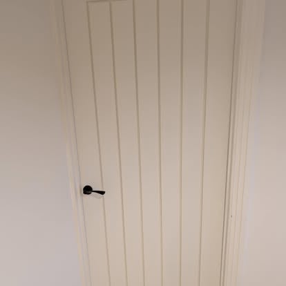 White vertical panel interior door with black handle fitted