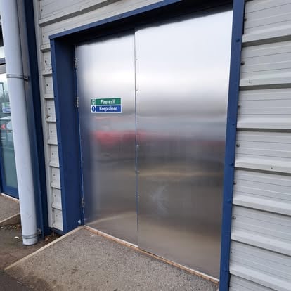 Stainless steel fire exit double doors on commercial building