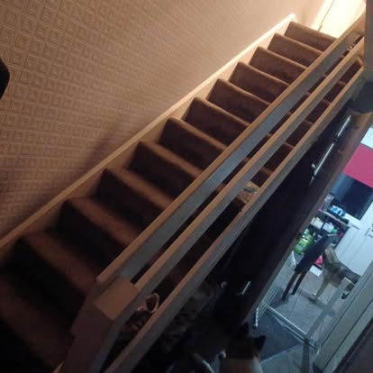 New pine stair balustrade being fitted carpet stairs