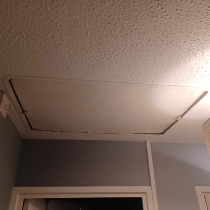 Old ceiling loft hatch panel before replacement