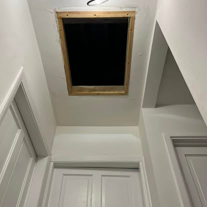 Loft hatch opening created with timber frame