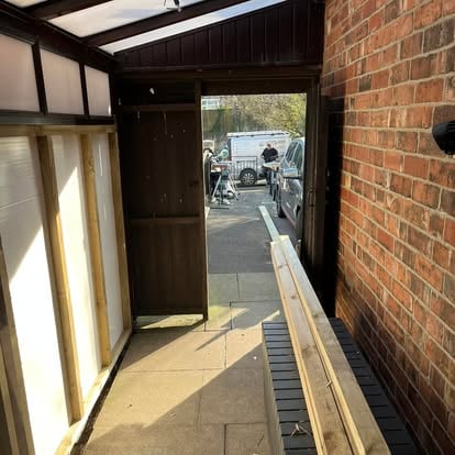 Lean-to interior with polycarbonate roof and worker outside