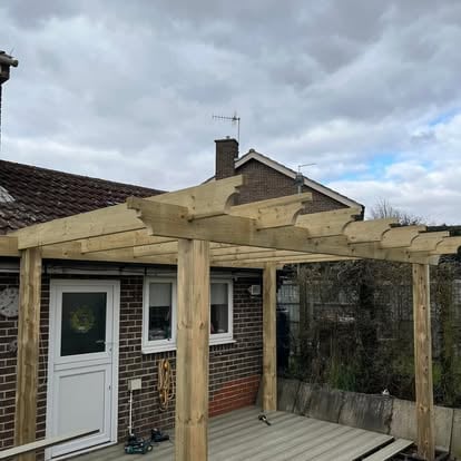Completed grey composite decking with new timber pergola