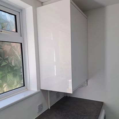 Utility room wall cabinet dark worktop and washing machine
