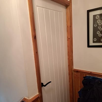 White panelled interior door with pine frame surround