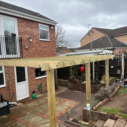 Wide view of pergola with polycarbonate panels being fitted