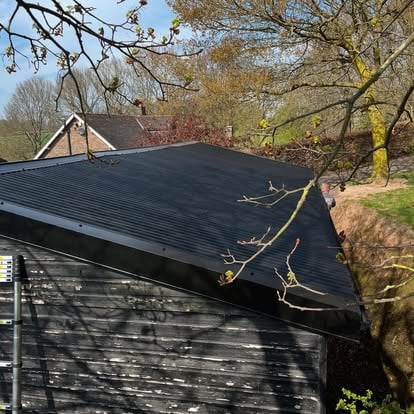 Completed black corrugated barn roof from above