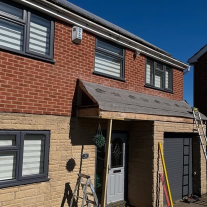 House 6 during roofline work with ladder and old canopy