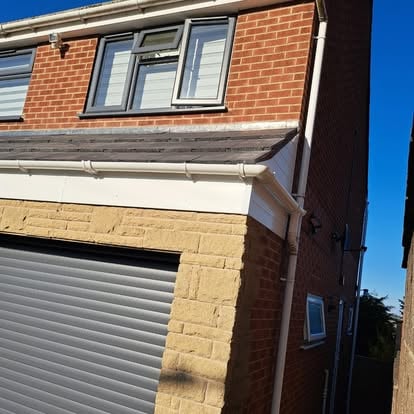 Semi-detached house white soffit completed at garage corner