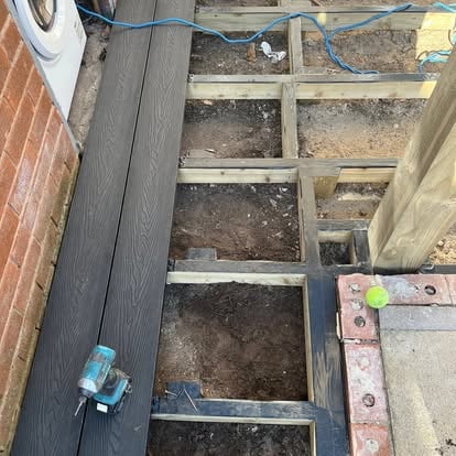 Dark composite decking joists subframe being laid