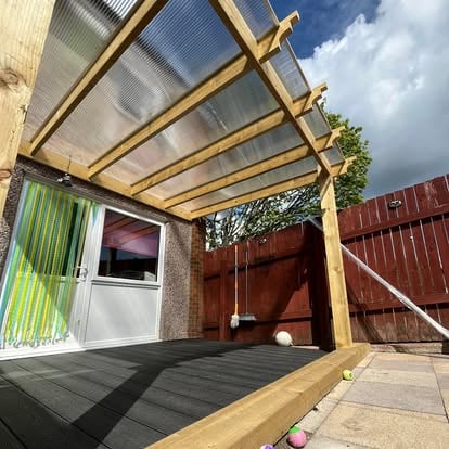 Completed polycarbonate covered pergola over dark decking