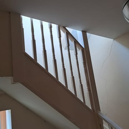 White turned spindle staircase viewed from below