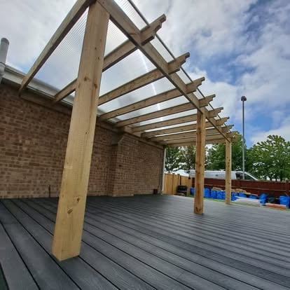 Grey composite deck with polycarbonate pergola roof