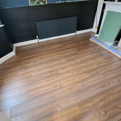 Wood-effect LVT floor in dark navy bay window room