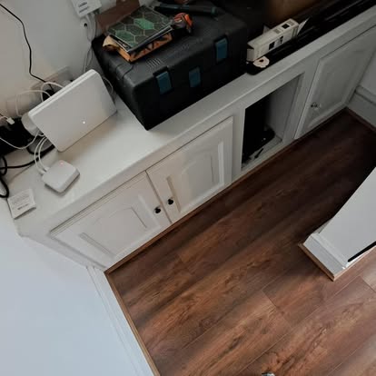 White shaker cabinets with LVT flooring being laid