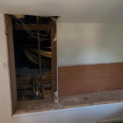 Wall knocked through with exposed timber stud framing