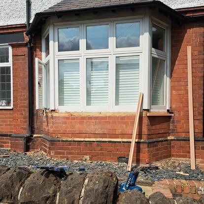 Bay window installation in progress with tools on ground