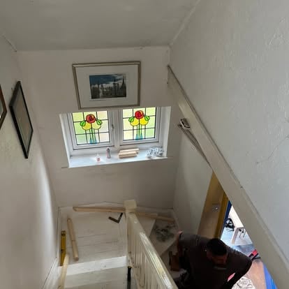 Completed pine handrail on white painted staircase