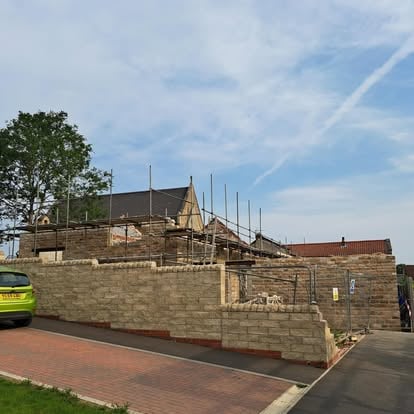 Historic building site with new stonework and scaffolding