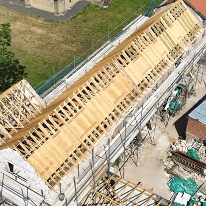 Aerial view of stone barn with new timber roof