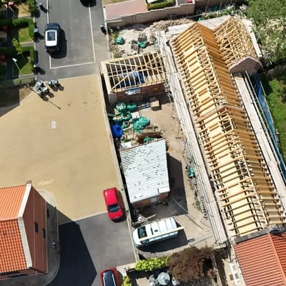 Aerial overview of historic building complex with new roofs