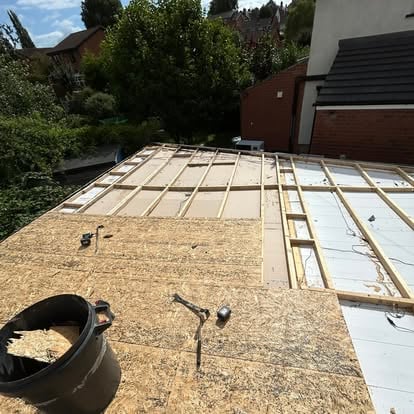 Flat roof timber joists being built for garden room
