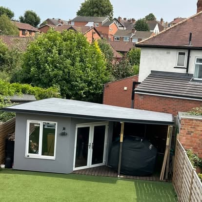 Completed grey render garden room with EPDM flat roof
