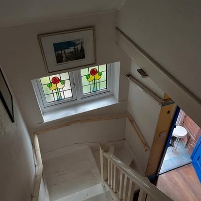 Staircase renovation with stained glass landing
