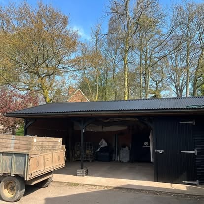 Open-sided barn with corrugated roof
