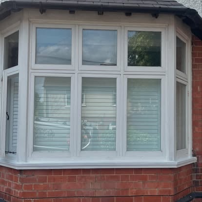 White UPVC bay window on brick house exterior