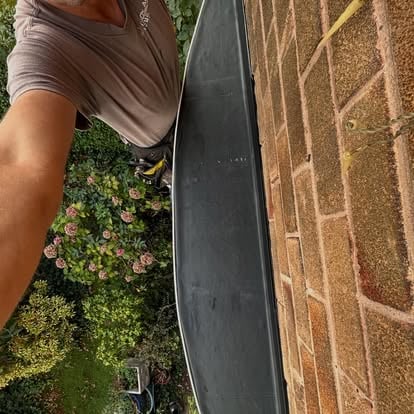Roofer applying EPDM strip to bay window roof