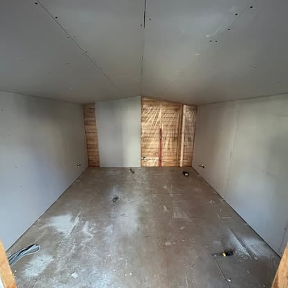 Small garden room interior at plasterboarding stage
