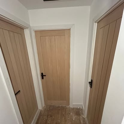 Three oak internal doors with black handles fitted