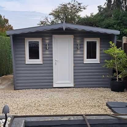 Completed grey garden room with white door
