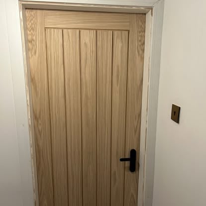 Oak T-and-G panel internal door with black handle