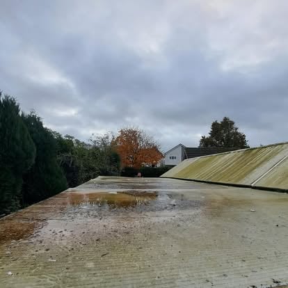 Deteriorated corrugated roof before replacement