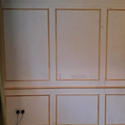 Wall panel moulding frames being fitted in lounge